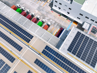 Solar-powered warehouse facility with freight trucks at loading docks. Eco-friendly logistics and...