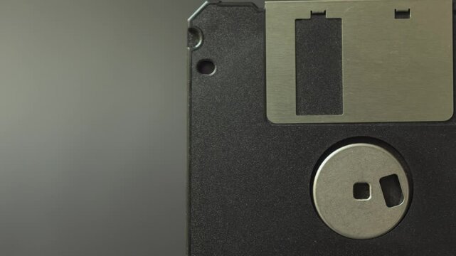 Close up of old floppy disks. Vintage data storage on diskette. Flexible disk of a magnetic storage medium in a square plastic enclosure. Smooth sliding motion