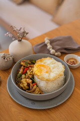 Stir-Fried Thai Basil Seafood with Rice and Fried Egg - Traditional Thai Street Food Dish.