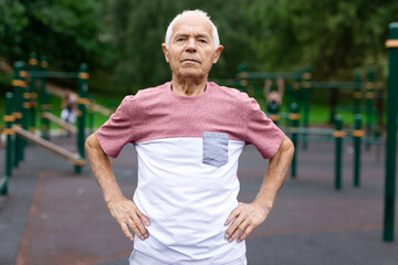 Senior man in sportswear standing in outdoor playground