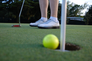 woman playing golf on the green fairway course