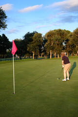 woman playing golf on the green fairway course