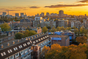 Skyline of Amsterdam in the autumn by sunset, view towards the Rivierenbuurt and Zuidas neighbourhoods