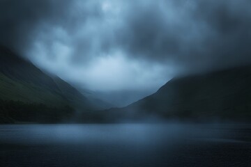 Clouds shroud the twilight sky above a calm lake, reflecting distant mountains and creating a serene atmosphere