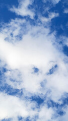 Lots of White cumulus clouds on blue sky. Colorful Beautiful vertical natural Mostly cloudy background.