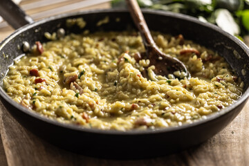 Italian risotto with pancetta, parmesan and parsley in a pan