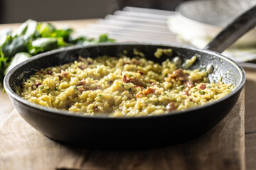Italian risotto with pancetta, parmesan and parsley in a pan