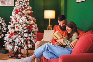 Young couple exchanging Christmas presents