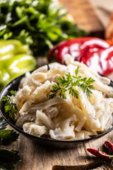 Precooked beef tripes in a bowl with vegetables and herbs ready for cooking