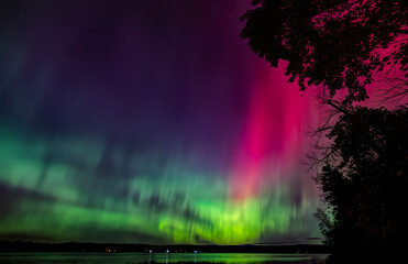 Northern Lights (Aurora Borealis) lights up the sky on a beautiful cold autumn night along the Ottawa river near Ottawa, Canada Oct 10, 2024