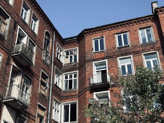 Fototapeta premium European disadvantaged area of ​​the city with old, unkempt buildings, peeling facades and garbage