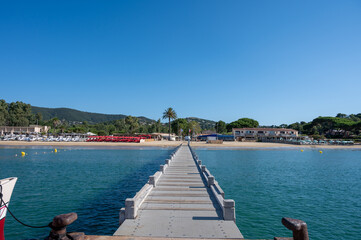Morning view on crystal clear blue water of Plage du Debarquement white sandy beach near Cavalaire-sur-Mer and La Croix-Valmer, summer vacation on French Riviera, Var, France