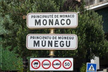 Driving car on French Riviera, road signes with directions to Monaco, english translation of board:...