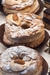 Freshly baked stuffed sweet Paris-Brest pastries in traditinal French bakery in small village in Provence
