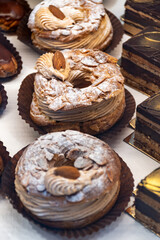 Freshly baked stuffed sweet Paris-Brest pastries in traditinal French bakery in small village in Provence