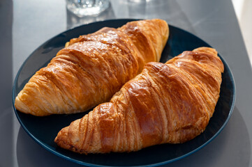 Fresh baked buttered croissants served in restaurant for continental or French breakfast close up