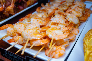 Typical snacks of Basque Country, pinchos or pinxtos skewers with small pieces of bread, fish, sea food, sweet green pepper served in bar in San-Sebastian or Bilbao, Spain