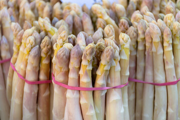 Fresh raw white asparagus vegetables for sale in local farmers market in Souillac, Dordogne,...