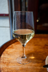 Glass of txakoli or chacolí slightly sparkling very dry white wine produced in Spanish Basque Country in typical pinchos bar in old part of San Sebastian or Donostia, Spain