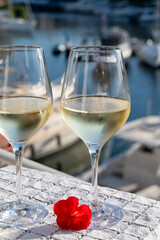 Glasses of cold white Cote de Provence wine in yacht harbour of Port Grimaud, summer vacation on French Riviera in Provence, France, wine tasting