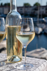 Glasses of cold white Cote de Provence wine in yacht harbour of Port Grimaud, summer vacation on French Riviera in Provence, France, wine tasting