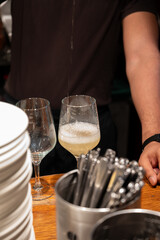 Pouring of txakoli or chacolí slightly sparkling very dry white wine produced in Spanish Basque Country in typical pinchos bar in old part of San Sebastian or Donostia, Spain