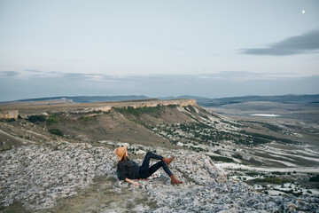 serene woman contemplating majestic mountain views across valley