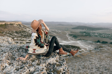 serene woman contemplating majestic mountain landscape from high summit