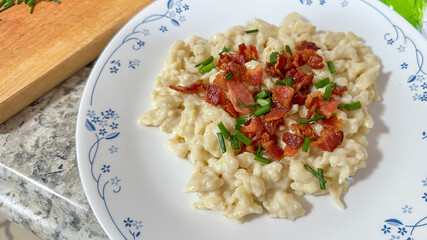 Traditional slovak dish dumplings with sheep cheese, chives and beacon from above