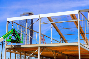 Building office is framed by metal structures made of steel beams when it is still in construction phase