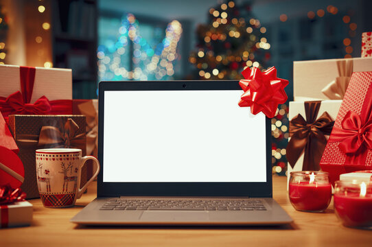Laptop and home interior decorated for Christmas