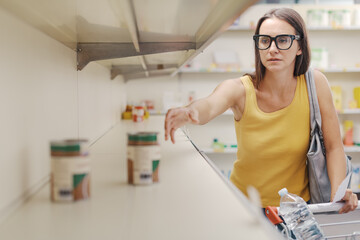 Desperate woman and empty supermarket shelves