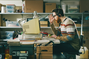Vintage style tech guy working with a computer