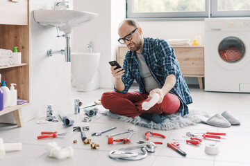 Confused man searching sink parts online