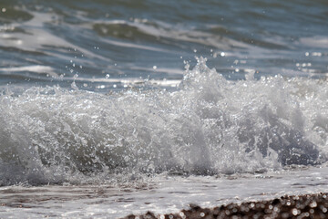 Waves washing onto beach sea froth