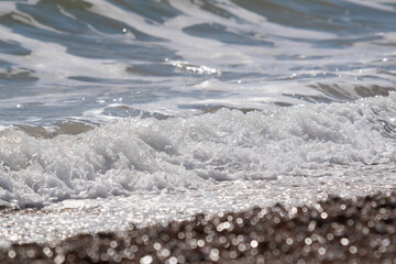 Waves washing onto beach sea froth