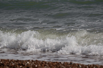 Waves washing onto beach sea froth
