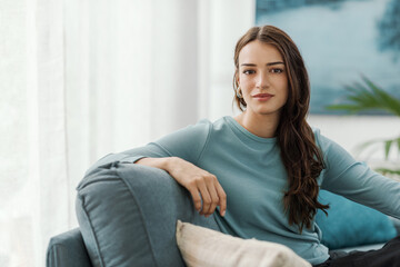 Fototapeta premium Beautiful young woman posing in the living room