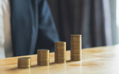 Businessman hand putting money coin stack with copy space, Saving money concept.