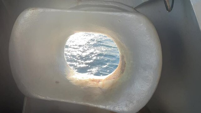 Hawsehole on a ship out at sea.