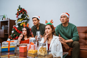 Friends gathered for a cozy Christmas movie night, enjoying festive snacks and celebrating