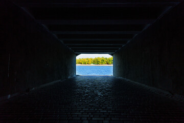 View From Tunnel Opening to Tranquil River Landscape