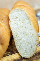 A loaf of sourdough bread on a wooden table, in a cut. a loaf of artisan bread.