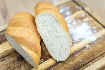 A loaf of sourdough bread on a wooden table, in a cut. a loaf of artisan bread.