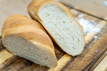 A loaf of sourdough bread on a wooden table, in a cut. a loaf of artisan bread.