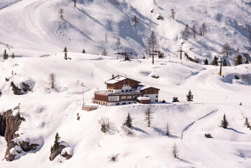 Winter mountain landscape with wooden house in Dolomite alps, Italy