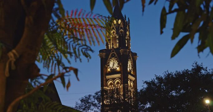 Rajabai Clock Tower In Evening Illumination. Clock Tower In Mumbai India. Confines Of Fort Campus Of University Of Mumbai. Modeled It On Big Ben In London. It Stands At Height Of 85 M Or 280 Ft
