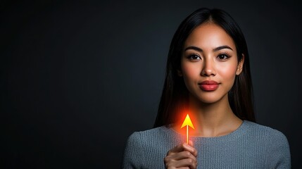 Obraz premium Confident Young Woman Holding Upward Arrow Symbol