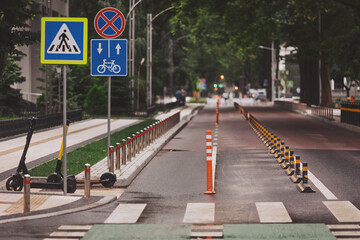 Straight two way cycle lane along side an asphalt road in the middle of city. Concept of safe...