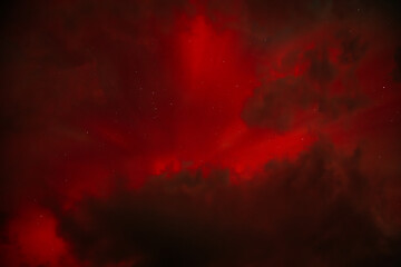 A dramatic view of the Aurora Borealis with intense red hues glowing through a cloudy night sky. The vibrant red contrasts with the dark clouds, creating a fiery and mysterious atmosphere.